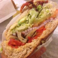 Vegetarian Bite Sandwich · Avocado, roasted peppers, button mushrooms, sun-dried tomatoes, red onions and hummus on whe...