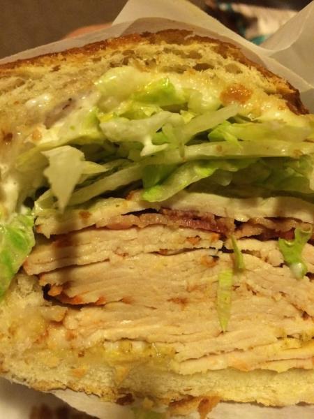 Napa Sandwich · Cracked pepper turkey, brie cheese, chipotle aioli, lettuce, tomato, and onions on a sourdough roll.