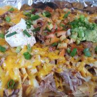 Pulled Pork Nachos · White corn chips topped with slow smoked pulled pork, BBQ sauce, a blend of cheeses, sour cr...