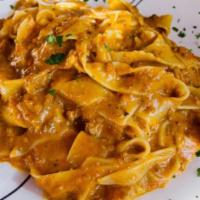 Pappardelle alla Bolognese · Large fettuccine, ground or beef, pork, carrots and tomato.