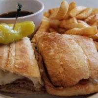 French Dip Sandwich · Tender roast beef slices on French bread with a cup of au jus for dipping. Served with fries...