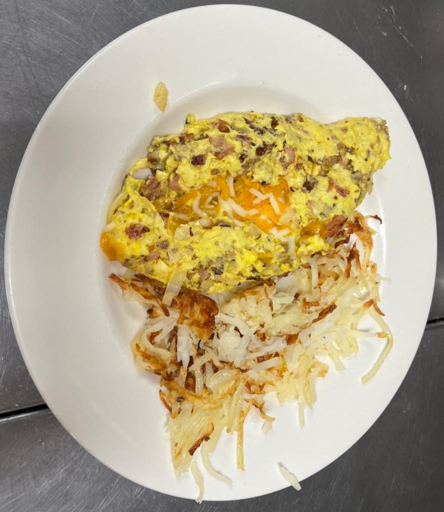 Meat Lover’s Omelette · A meat lover’s dream of diced ham off the bone, bacon, and sausage with cheddar and mozzarella cheeses. 
