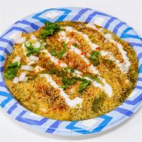 Papri Chaat · Flat puri with toppings of yellow peas, yogurt, imli, and cilantro chutney and spices.
