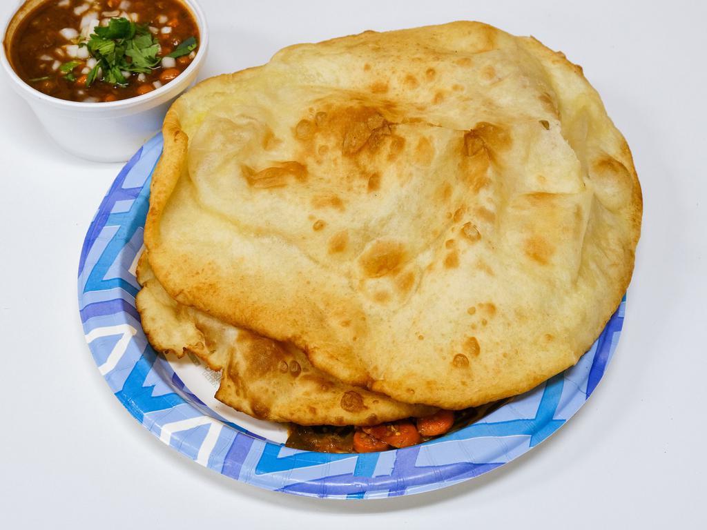 Paneer Paratha · Grilled paratha stuffed with paneer (home made Indian cheese) and spices. Served with yogurt and pickles.