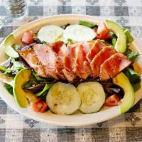 Seared Tuna Salad · Seasoned tuna, fresh slices of avocado served over crispy wontons, tomatoes, cucumbers and m...