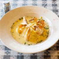 Shrimp and Grits · Grilled shrimp over Original Grit Girl smoked gouda cheese grits, topped with a lemon butter...