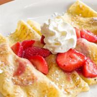 Fresh Strawberry Crepes · Fresh strawberry-filled crepes, topped with even more strawberries and fresh whipped cream.