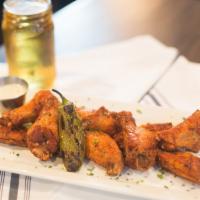 Wings · Marinated jalapeno wings with spicy garlic rub.