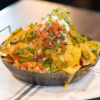Social Nachos  · Signature cheddar queso, fresh guacamole and all the fixings.