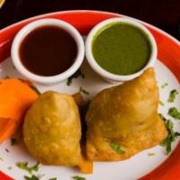 Dhaba Special Samosa · Spiced potatoes and peas filling pastry.