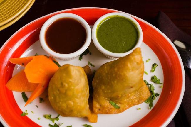 Dhaba Special Samosa · Spiced potatoes and peas filling pastry.