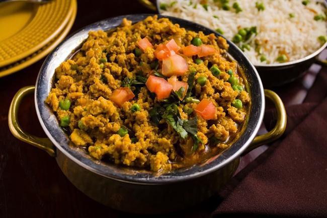 Chicken Keema Mutter · Minced chicken prepared with onions and tomatoes topped with tomatoes and onions.