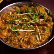Baingan Bharta · Eggplant smoked in tandoor, minced, and prepared with onions, tomatoes, and garden herbs top...