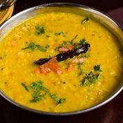 Tadka Daal · Yellow daal (lentils) cooked with cumin, garden herbs and topped with cilantro