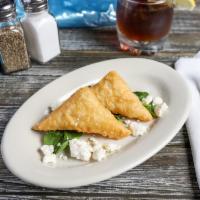 Tiropita · Filo dough stuffed with Greek cheese and served with spinach and feta cheese.