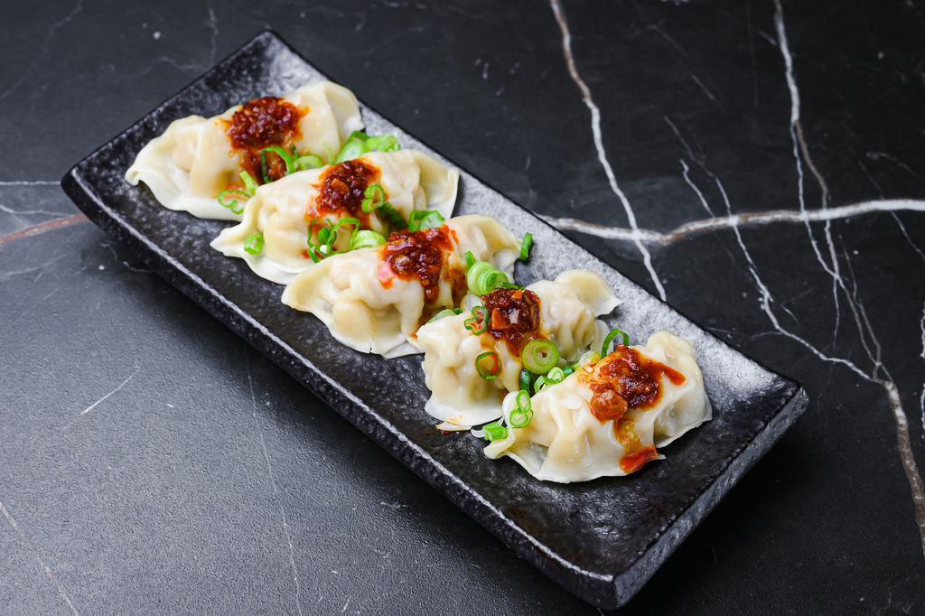 Garlic Chili Dumplings · pork dumplings, warmed up and served with House Chili Oil and Scallion, (5) pieces per order. 