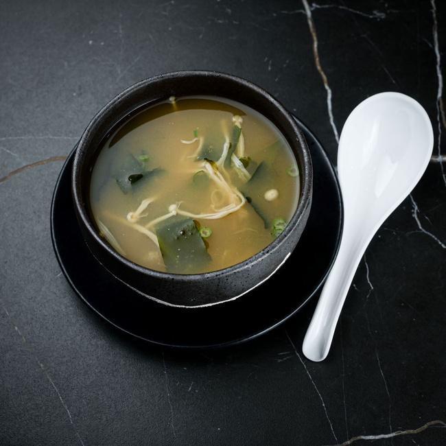 Miso Soup · Miso soup is a traditional Japanese soup consisting of a dashi stock into which softened miso paste is mixed, included is: scallion, enoki mushrooms and seaweed. 