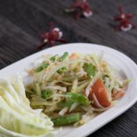 Thai Papaya Salad · Green papaya, string beans, tomatoes, dried flake shrimp and peanuts tossed in sweet garlic ...