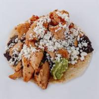 BRAISED CHICKEN TACO · Braised Chicken,  Smashed Avocado, Black Bean Refritos, Queso Fresco, And Your Choice Of Sal...