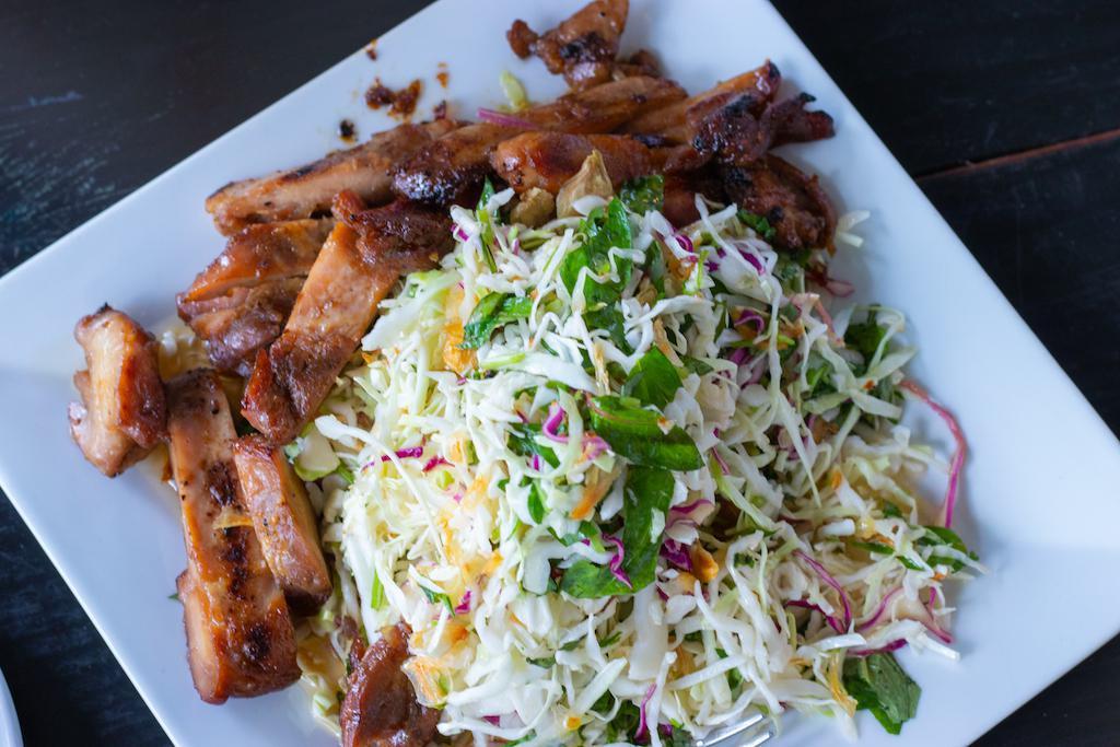 Chicken Cabbage Salad · Grille Chicken, mixed cabbage, fried shallots, and cilantro tossed in a lime vinaigrette dressing.


