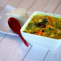 Yellow Coconut Curry · Yellow coconut curry with sweet potatoes, carrots, broccoli, bamboo shoots, served steamed r...