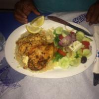 Stuffed Chicken Breast · With feta cheese over rice. Served with Greek salad.