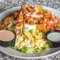 Mels Crispy Chicken Salad · Fresh diced tomatoes, crumbled bacon, sliced hardboiled egg, and shredded jack and cheddar c...