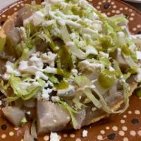 Tostada · Your choice of meat, lettuce, queso fresco, and sour cream.