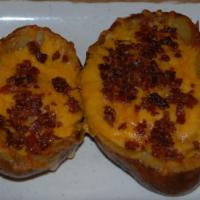 Potato Skins · Crisp baked potato skins piled high with bacon, melted cheddar cheese, jalapeno peppers and ...