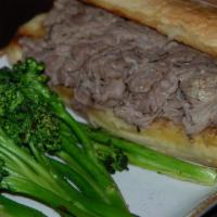 Garlic French Dip · Thinly sliced roast beef seasoned with garlic and served with a cup of hot beef au jus for d...