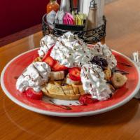 Tropical Waffle · Comes with fresh banana, strawberries, blueberries, whipped cream, and chocolate syrup.