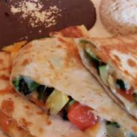 Quesadilla Oaxaca · On flour tortilla stuffed with chorizo and quesillo cheese served with rice and beans.