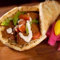 Falafel Wrap · Falafel patties served with veggies tomatoes, onions and choice of sauces. Vegan.