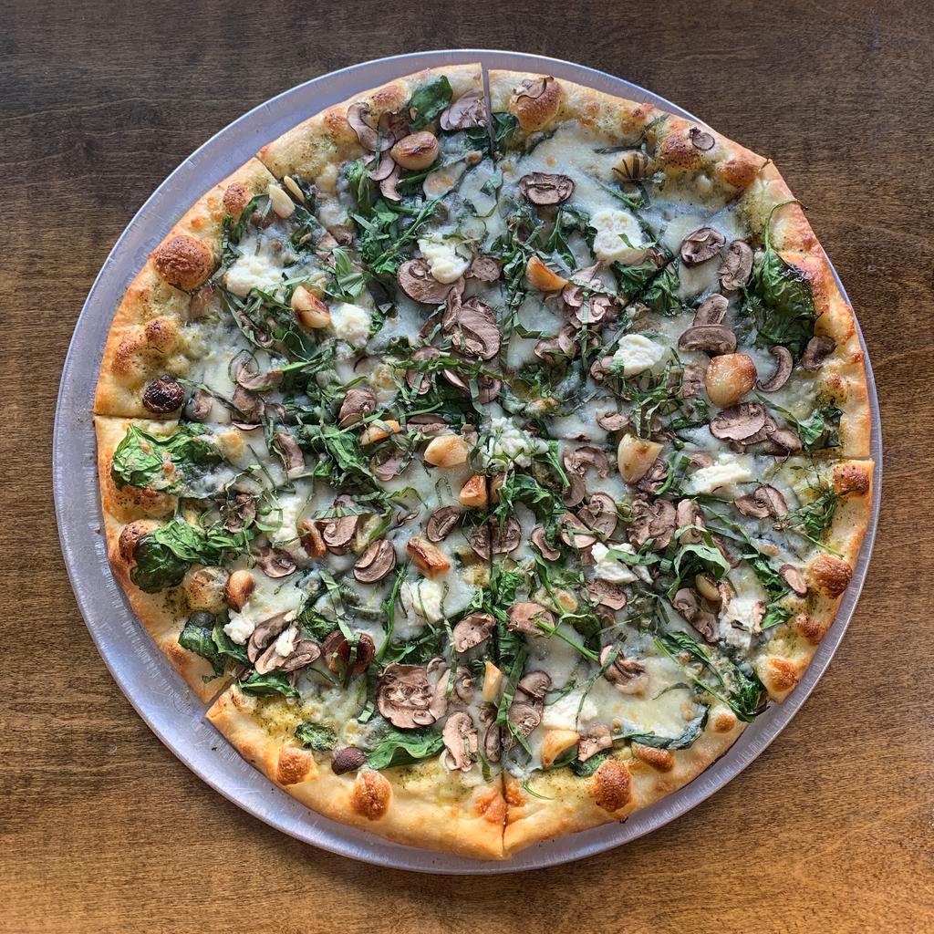 Green Goat Pie · Spinach, mushrooms, roasted garlic, and ricotta mix, on a mozzarella and in-house basil puree base. Topped with fresh basil.