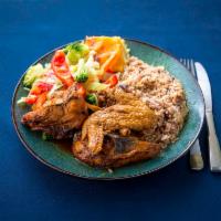 Brown Stew Chicken Full Meal · Brown stew chicken served with rice and peas and steamed vegetables.