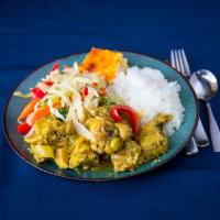 Curry Chicken Full Meal · Curry chicken served with rice and peas and steamed vegetables.