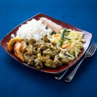 Curry Goat Full Meal · Curry goat served with rice and peas and steamed vegetables.