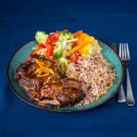 Jerk Pork Full Meal · Jamaican jerk pork served with rice and peas and steamed vegetables.