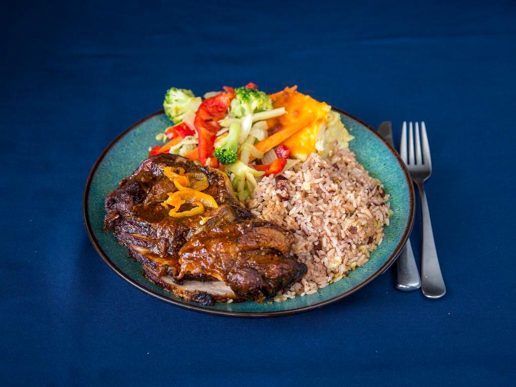 Jerk Pork Full Meal · Jamaican jerk pork served with rice and peas and steamed vegetables.