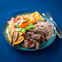 Pepper Steak Full Meal · Pepper steak served with rice and peas and steamed vegetables.