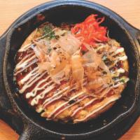 Okonomiyaki · Japanese savory pancake with cabbage, bean sprouts, red ginger, dried bonito and pork.