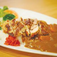 Grilled Chicken Curry · Grilled chicken with rice and a side of salad.