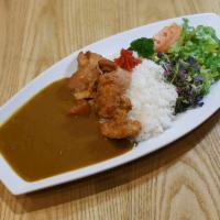 Chicken Katsu Curry · Breaded Fried chicken with rice and a side of salad.