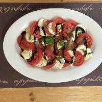 Mozzarella and Tomato Salad · Tomato, mozzarella cheese, fresh basil, olive oil and a balsamic glaze.