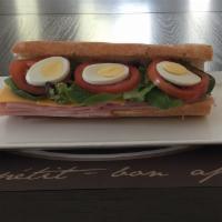 1. Belgian Sandwich · Black Forest ham, Gouda cheese, lettuce, hard-boiled eggs, pickles, tomatoes, and mayonnaise.
