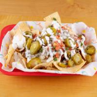 Taco Truck Nachos · Grilled juicy chicken breast or beef fajita, topped with pico, jalapenos, sour cream, grille...
