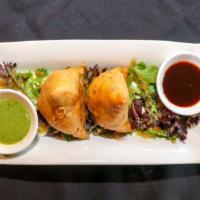 2 Pieces Vegetable Samosa · Triangular pastry filled with spiced potatoes, onion and peas.