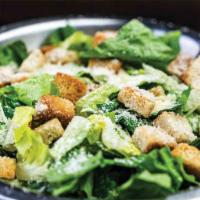 Caesar Salad  · Romaine lettuce, garlic croutons, & Parmesan cheese tossed with our caesar dressing.