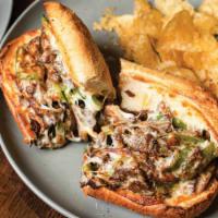 Philly Cheesesteak  · Philly cheesesteak, red onions, green peppers, & provolone cheese on a toasted Italian hoagie,