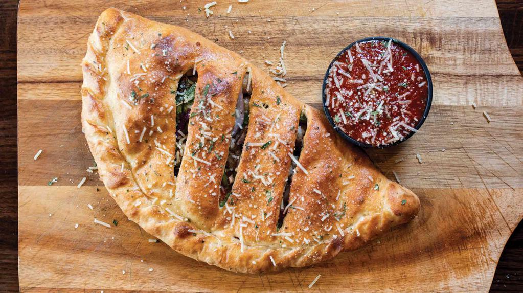  The Popeye Calzone · Oil base with fresh spinach, roasted garlic, feta cheese, roasted red peppers, & red onions.